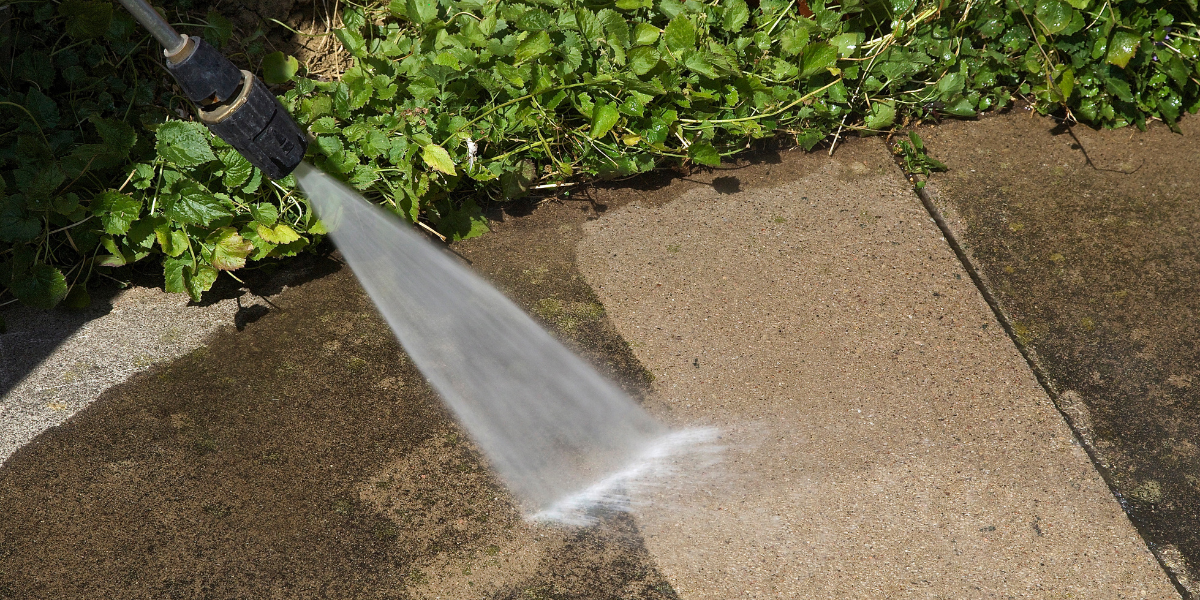 Driveway and sidewalk pressure washing service removing dirt and stains in West Chester, OH