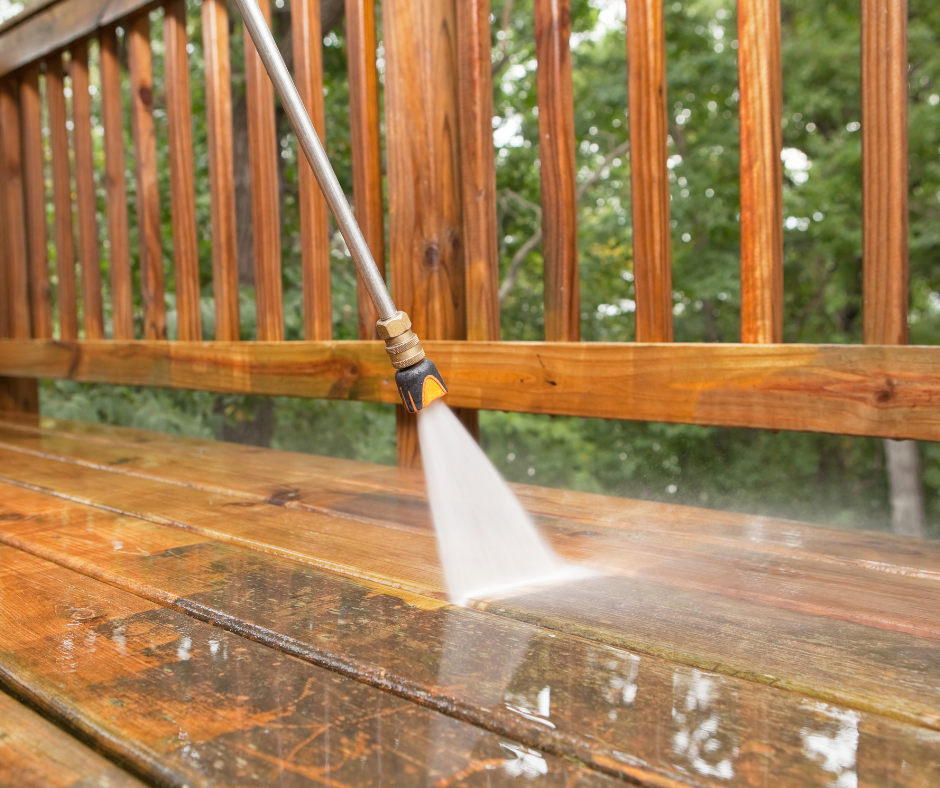 Pressure washing wooden deck to remove dirt, mildew, and restore natural wood finish in West Chester OH