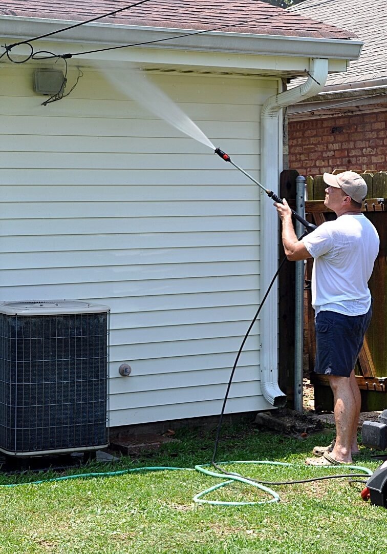 Technician power washing vinyl siding on residential home in West Chester, OH